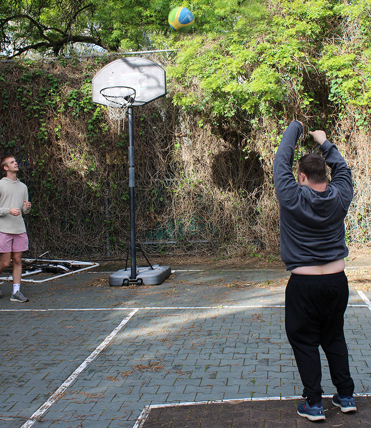 Mentor and customer playing basketball