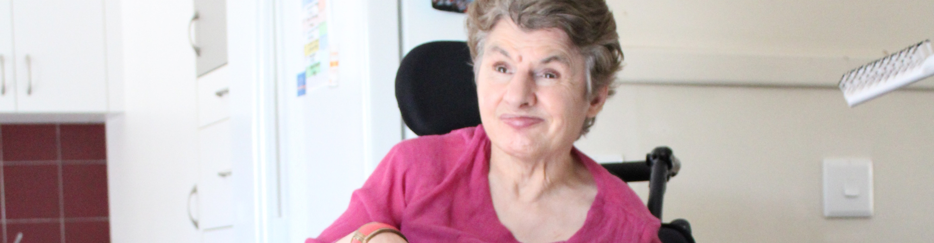 Woman in wheelchair smiling at camera