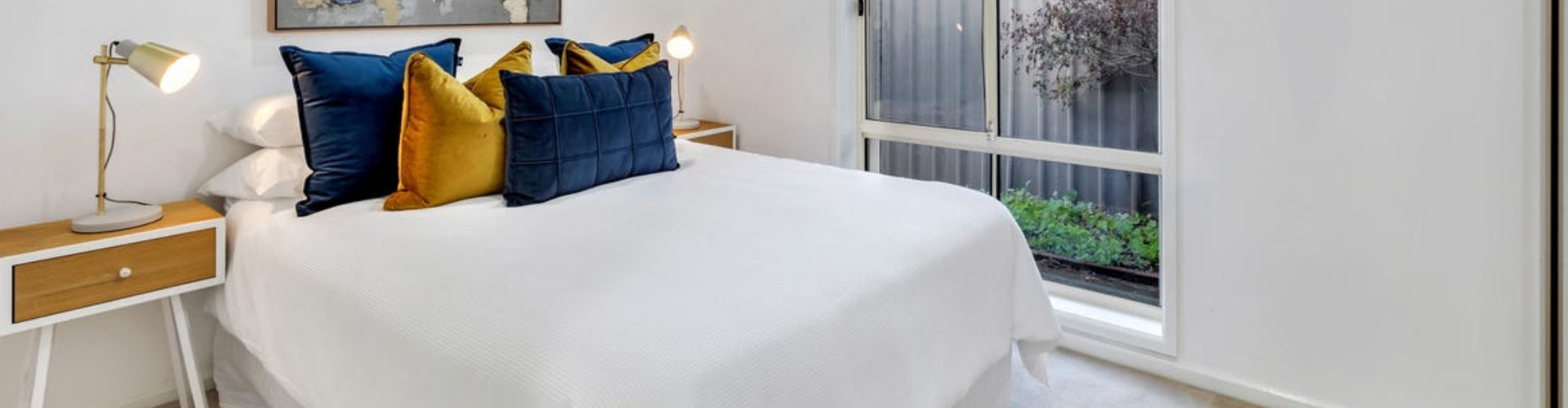 Bed with white sheets situated in bedroom