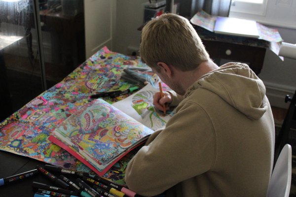 Young man drawing in a sketchbook